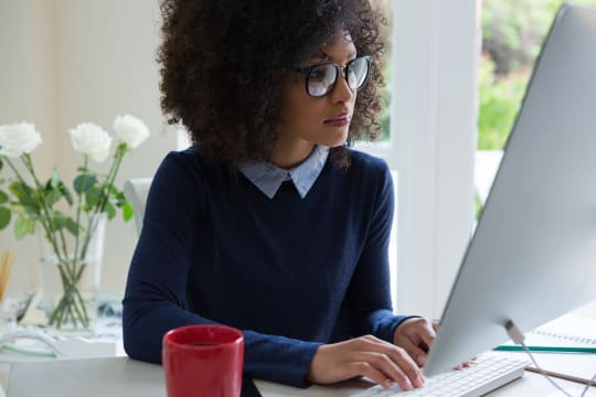 Woman typing on computer