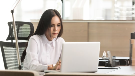 Woman looking at laptop