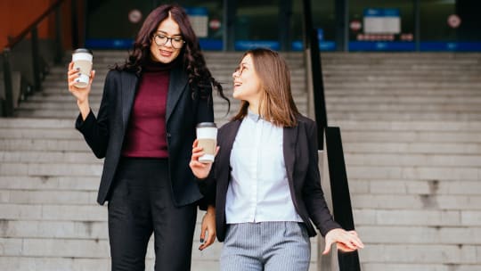 Women walking with coffee