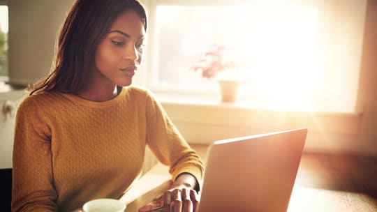 woman at home on her computer