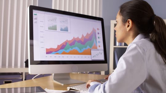 data scientist looking at computer