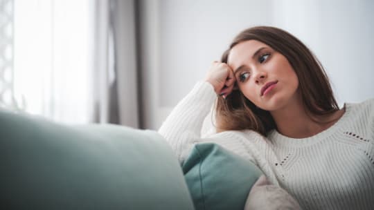 Woman thinking at home