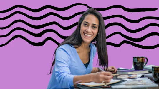 woman writing at her desk