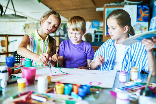 Three children painting