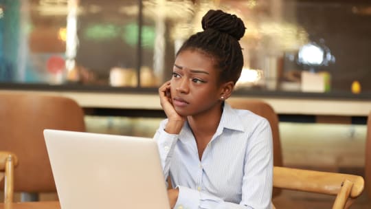woman looking worried on laptop