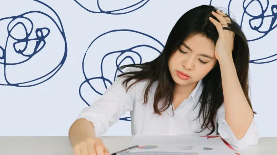 woman looking distressed in front of her laptop