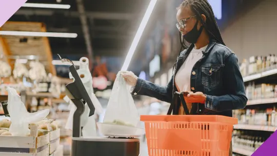 A person doing grocery shopping, illustrating how to save money on groceries