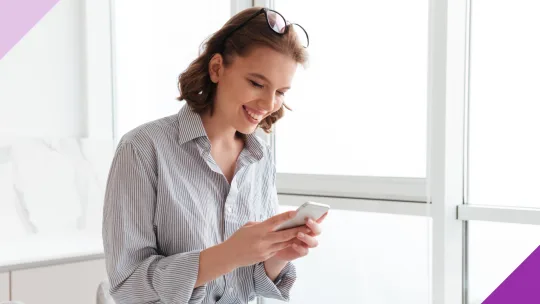 A young woman having fun while typing at her phone to illustrate that are fun and free personality tests out there