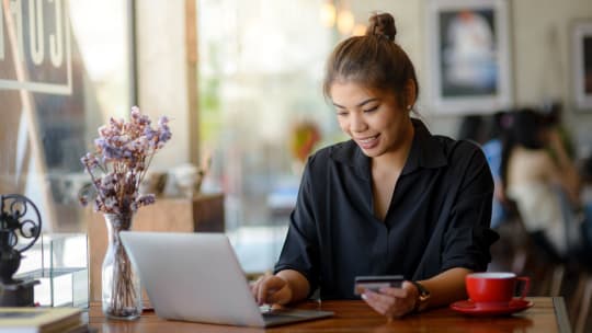 Woman with laptop and credit card