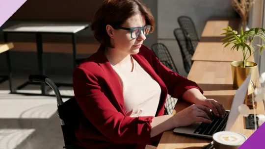 Professional typing at a computer, illustrating working part-time while collecting disability insurance