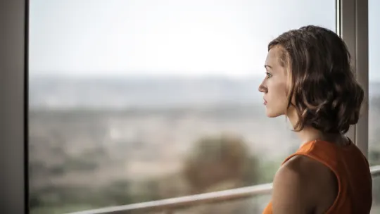 Woman looking out window