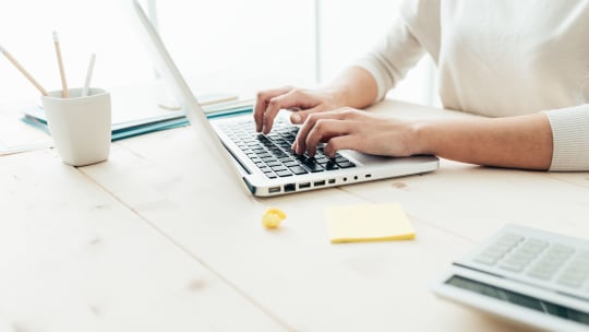 Woman typing on computer