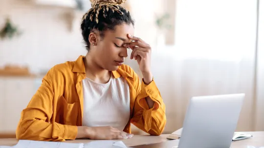 Frustrated woman on laptop
