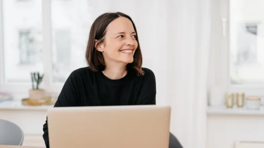 Happy woman looking at phone