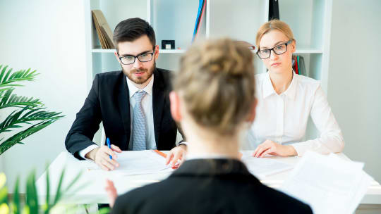 Man and Woman Conducting Interview at Work