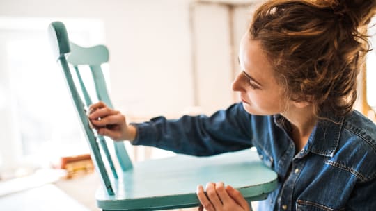 woman touching up chair