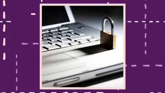 a gold lock placed on a silver laptop