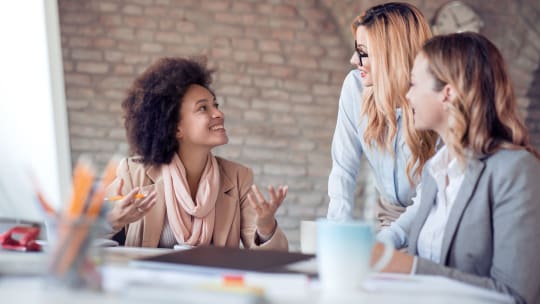 colleagues making eye contact in meeting