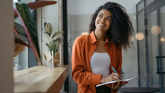 woman writing down career goals