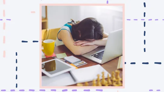 a woman with her head down on her desk