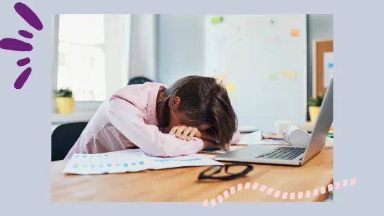woman with head down at desk