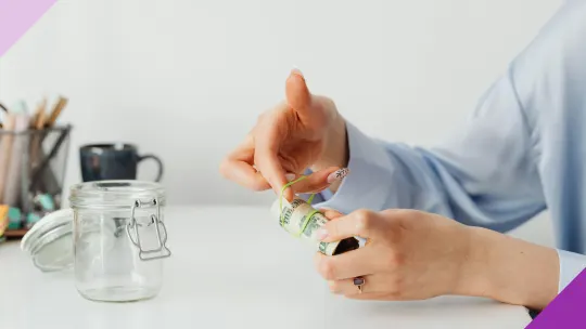Woman saving money, illustrating how to save money on basic needs