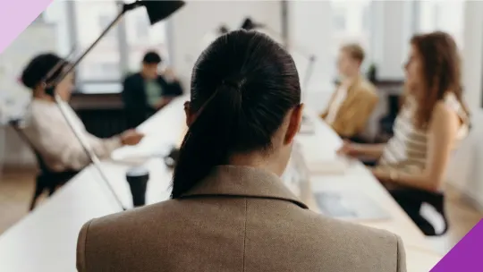 A woman facing down while entering her workplace, illustrating the importance of learning how to protect yourself in a toxic work environment