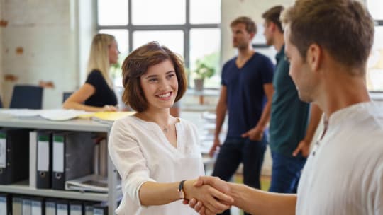 People smiling and shaking hands