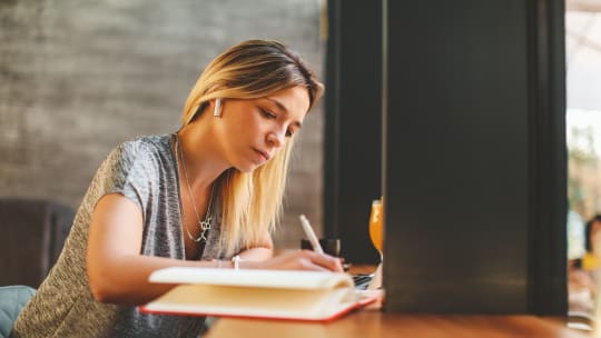 Woman writing in her notebook