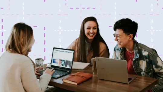 group of friends on laptops laughing together