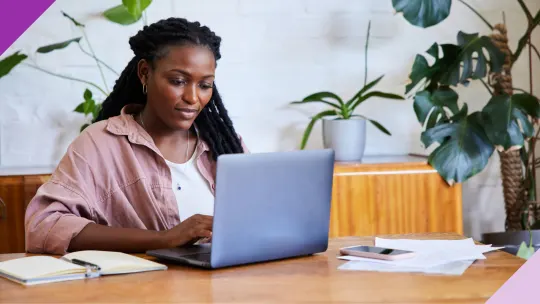 Professional writing a thank you letter after an interview on a computer