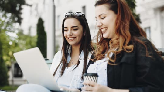 Two women talking on a bench