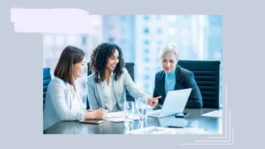 three woman sitting at a table.