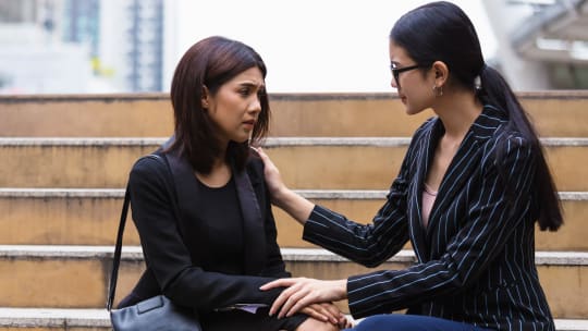 Woman consoling coworker