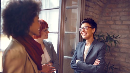 women chatting in the workplace