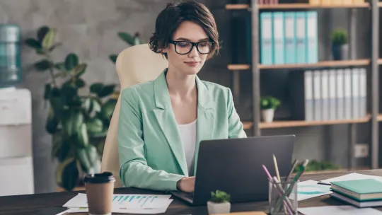 woman typing at desk