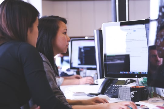 Two women looking at computer