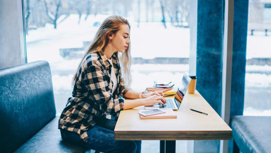 woman doing research in cafe