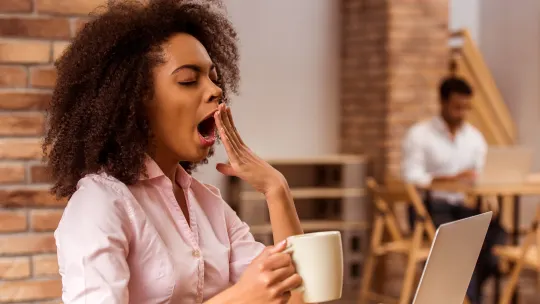woman yawning at work