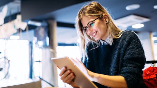 Woman smiling at tablet