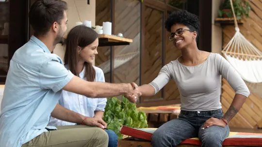 wedding planner shaking hands with couple