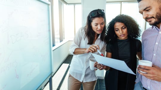 People meeting about paper. 
