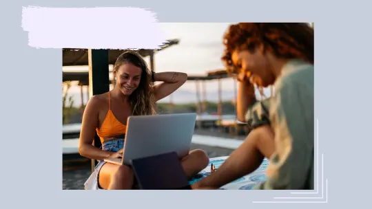 Two women in front of laptops.