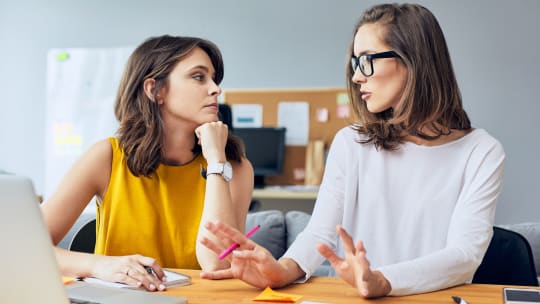 Two women talking at work