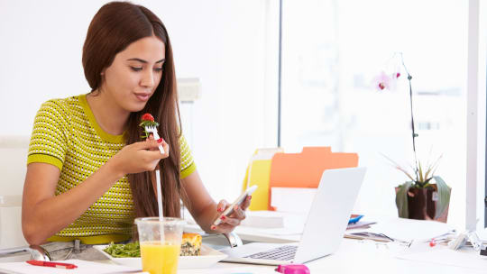 Woman eating at desk