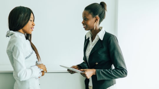 Two women talking at work