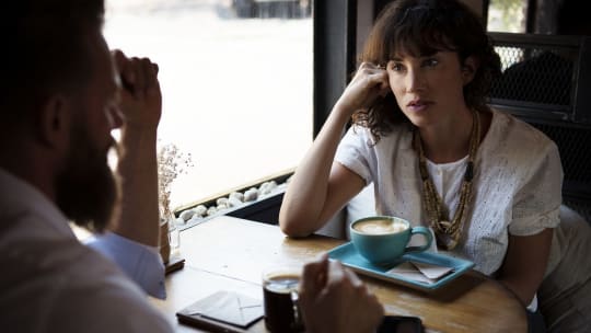 Men and woman at table in cafe