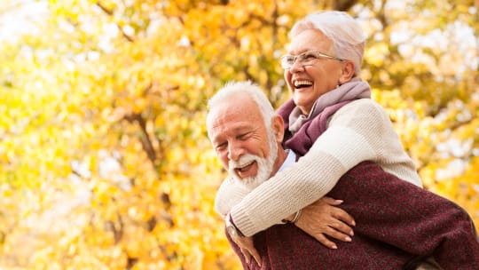 husband giving wife a piggyback ride