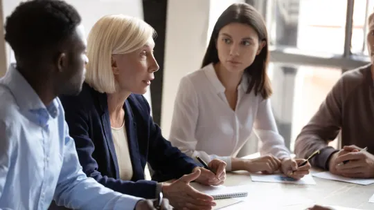 Three people in a meeting.