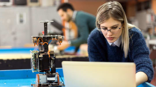 Woman building robot